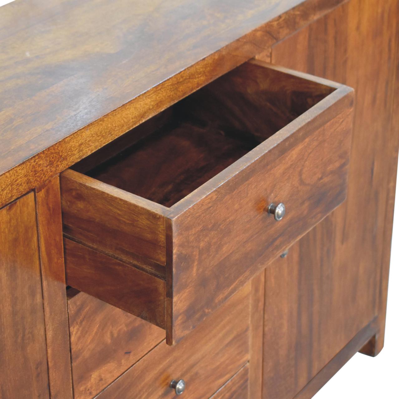 Wooden desk with open drawer, close-up view.